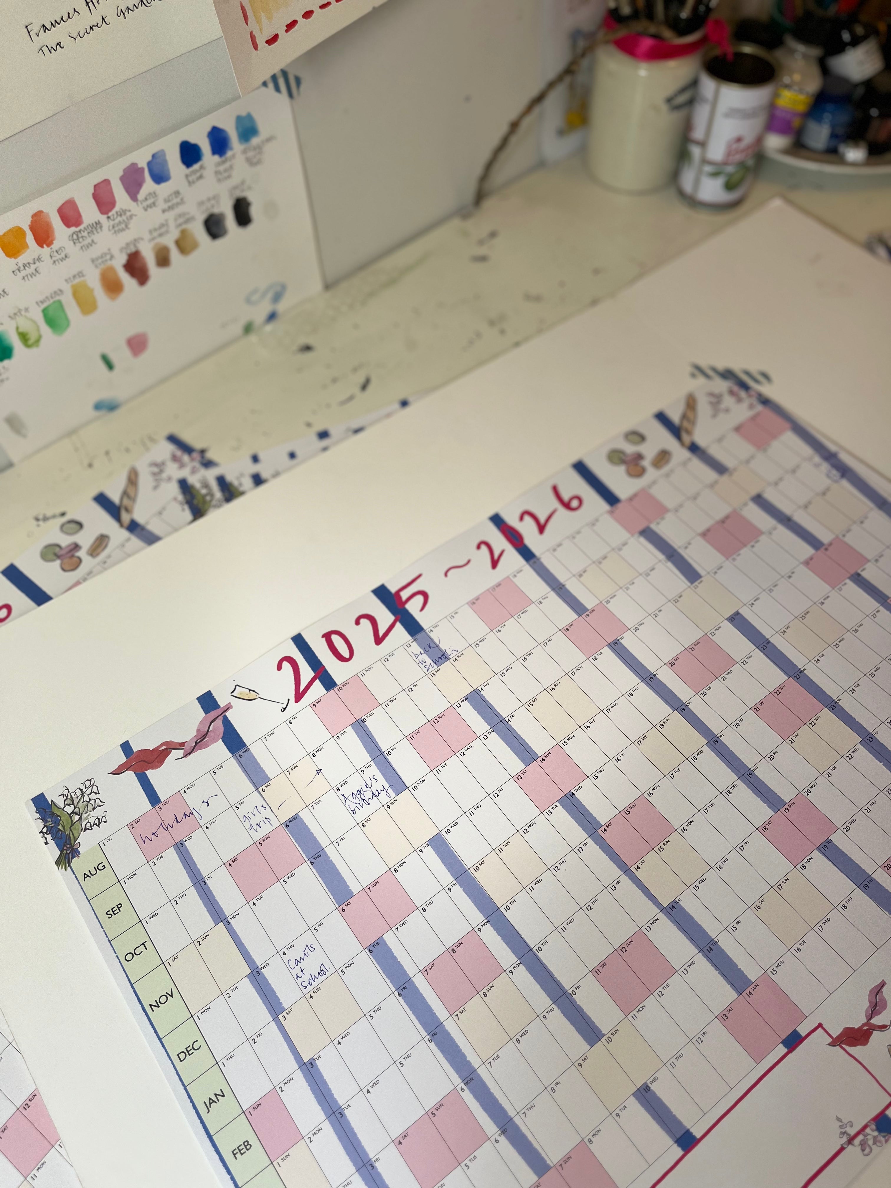 Calendar with colorful design on a desk with stationery items.
